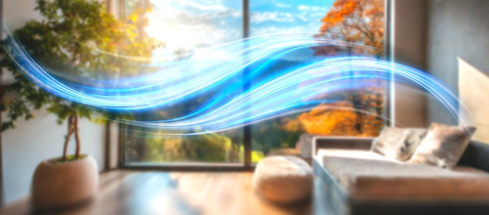 A bright living room scene with a large window and blue flowing lines representing air.