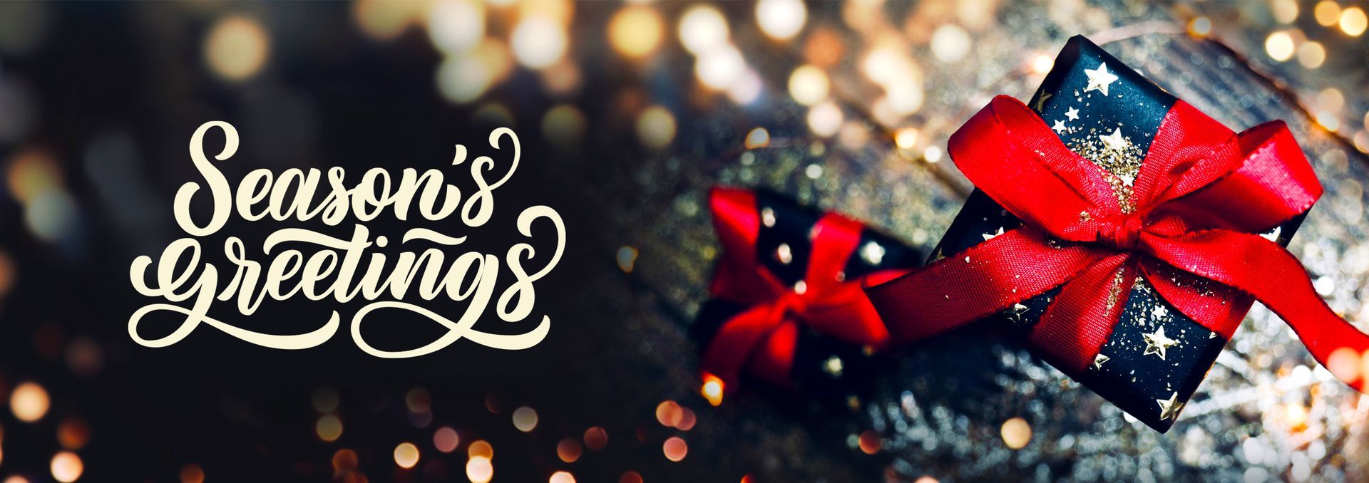 Season's Greetings A christmas present with a red bow and the words `` season 's greetings ''.