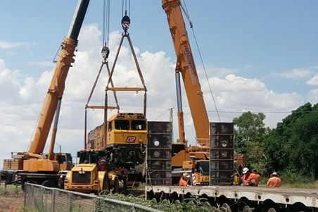 Two Cranes Are Lifting a Train onto A Trailer — Linmar Cranes & Haulage in Karumba, QLD