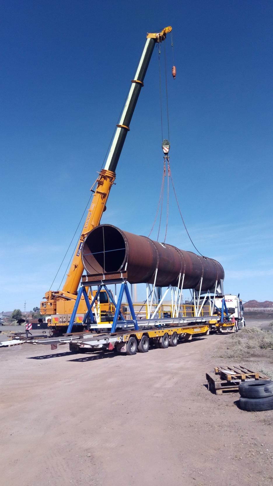A Large Pipe is Being Lifted by a Crane on a Trailer — Linmar Cranes & Haulage in Kalkadoon, QLD