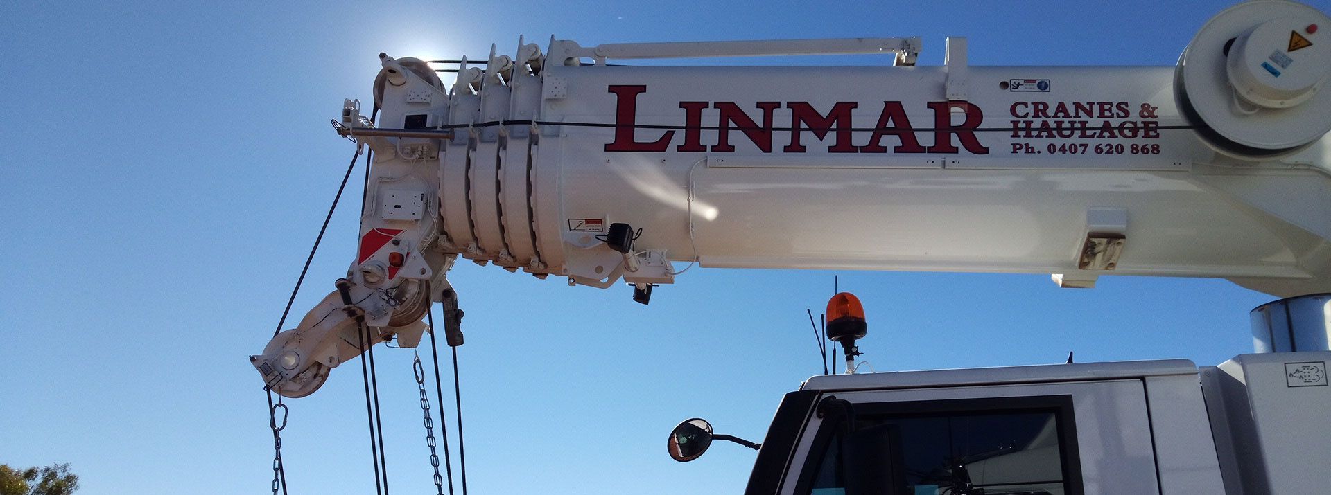 A Linmar Crane with A Blue Sky in The Background — Linmar Cranes & Haulage in Karumba, QLD