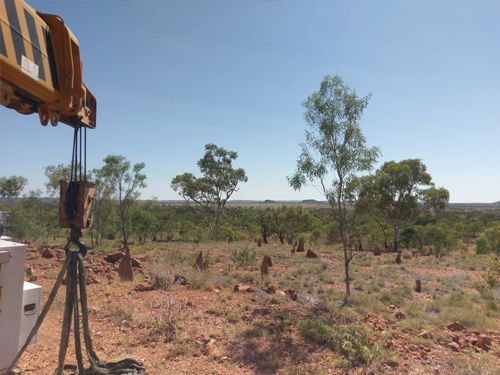 A Crane is Sitting in the Middle of a Desert With Trees in the Background — Linmar Cranes & Haulage in Kalkadoon, QLD