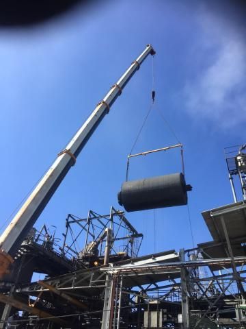 A Large Pipe Is Being Lifted by A Crane in A Factory — Linmar Cranes & Haulage in Mt Isa, QLD