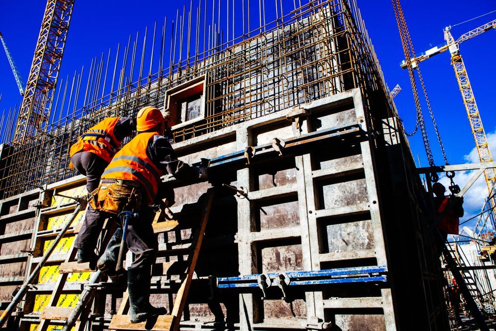 A Group of Construction Workers Are Working on A Building Under Construction — Trussted Frames & Trusses in Tamworth, NSW