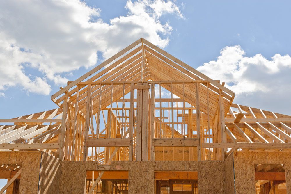 New Residential Construction House Framing Against A Blue Sky — Trussted Frames & Trusses in Maitland, NSW