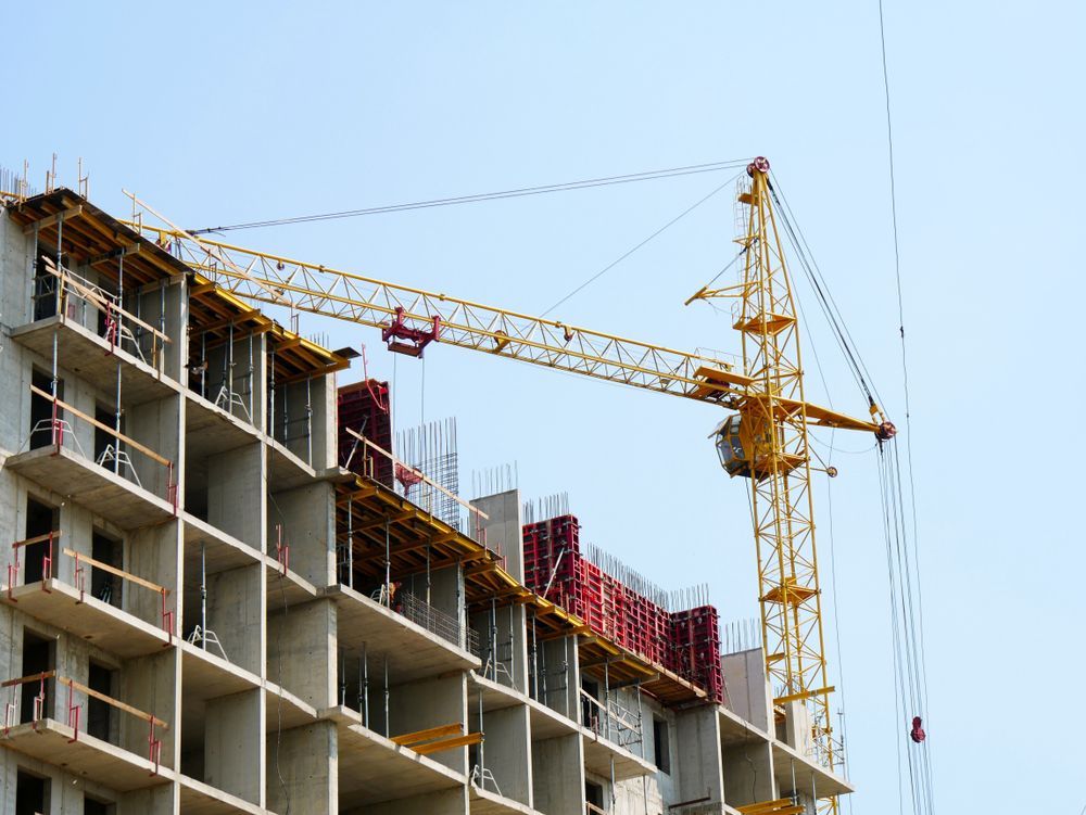 A Large Building Is Being Built with A Crane on Top of It —Trussted Frames & Trusses in Bennetts Green, NSW