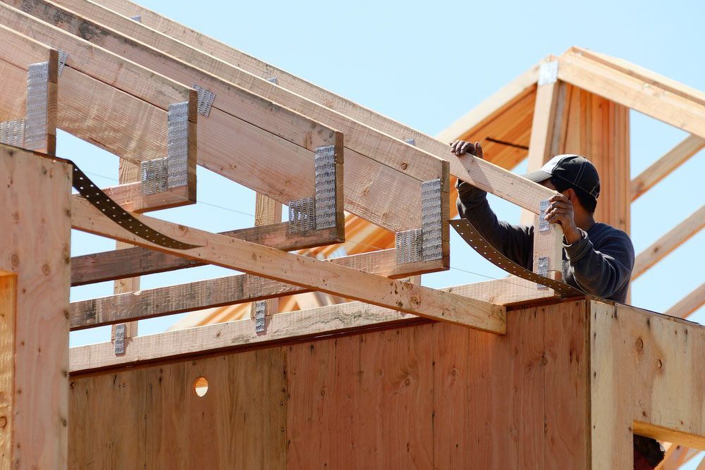 Carpenter Installing The Roof Truss System — Trussted Frames & Trusses in Cessnock, NSW