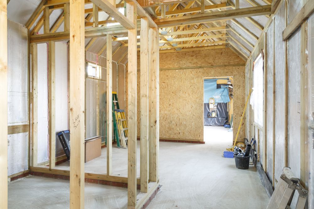 A Room Under Construction with Wooden Beams and A Ladder — Trussted Frames & Trusses in Bennetts Green, NSW