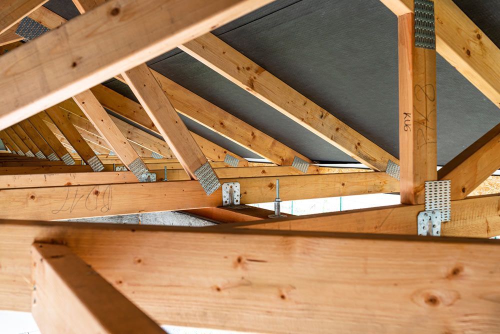 Roof Trusses Covered With A Membrane On A Detached House Under Construction — Trussted Frames & Trusses in Central Coast, NSW