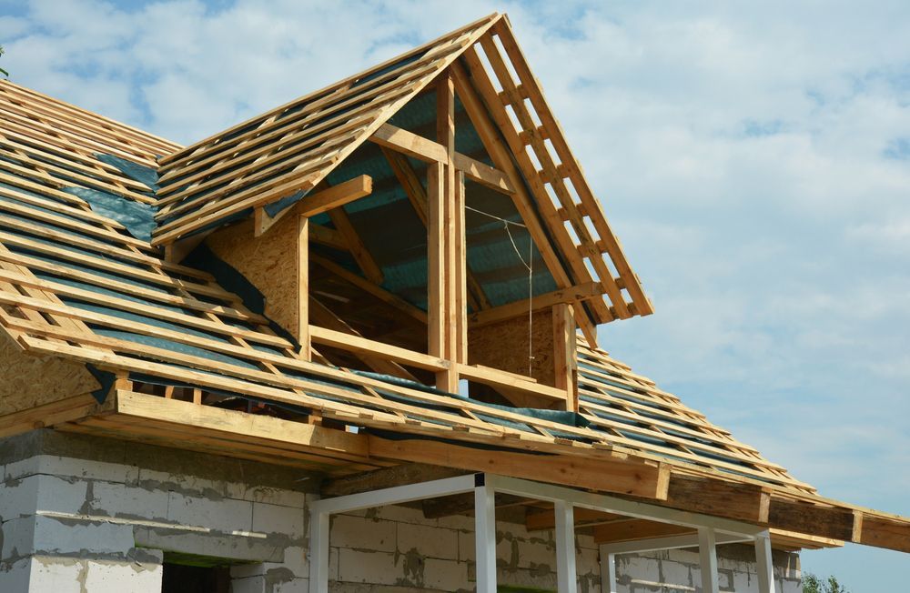 A House Is Being Built with A Wooden Roof and A Window — Trussted Frames & Trusses in Newcastle, NSW