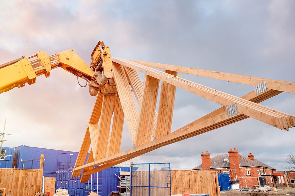 Forklift Shifting Roof Trusses On New Residential House — Trussted Frames & Trusses in Central Coast, NSW