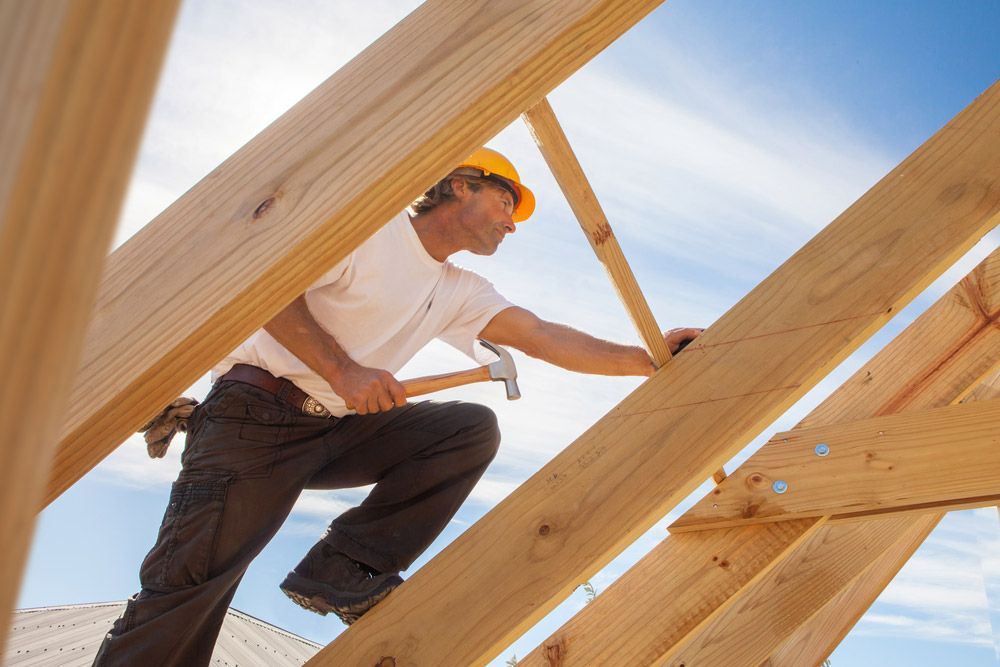 Builder Working On Roof Structure — Trussted Frames & Trusses in Armidale, NSW