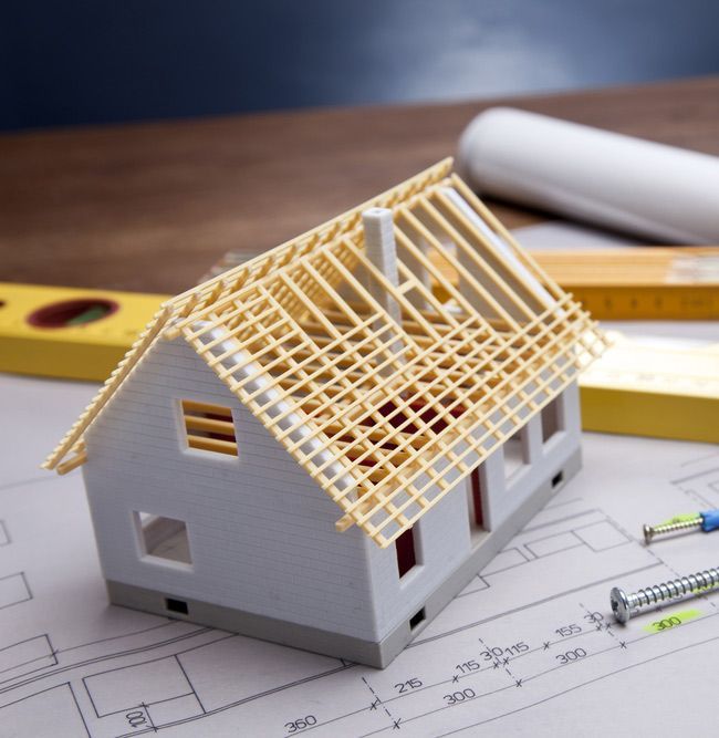 Construction Plans With Helmet And Drawing Tools On Blueprints — Trussted Frames & Trusses in Forster, NSW