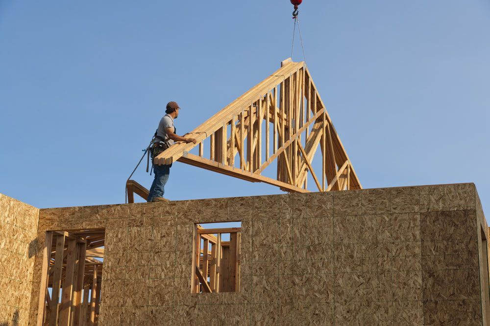 Roof Trusses Being Hoisted Onto Roof — Trussted Frames & Trusses in Armidale, NSW