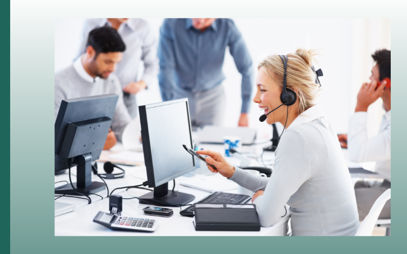 Call center team working at computers, with a headset-wearing agent in the foreground