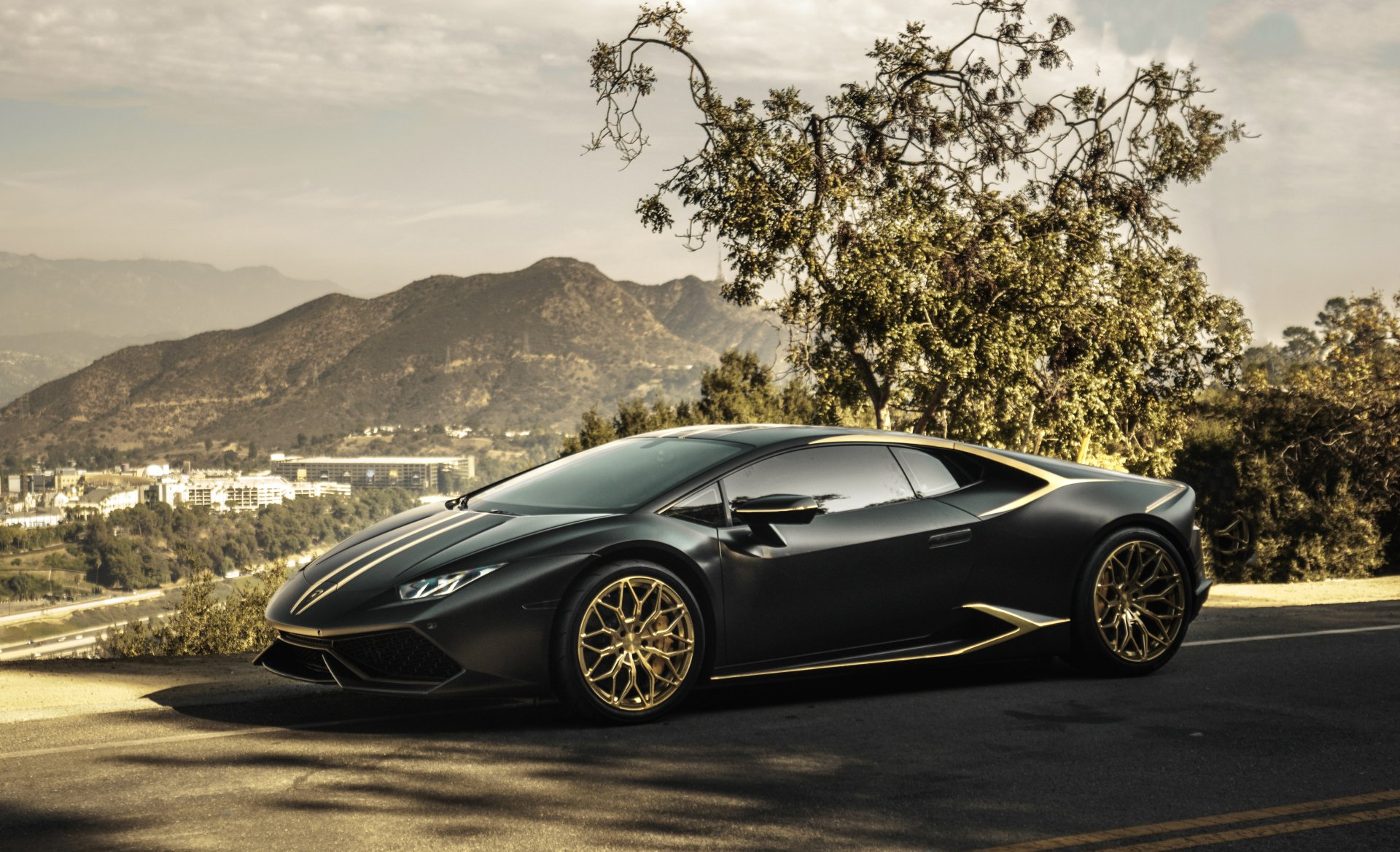 A black sports car is parked on the side of the road