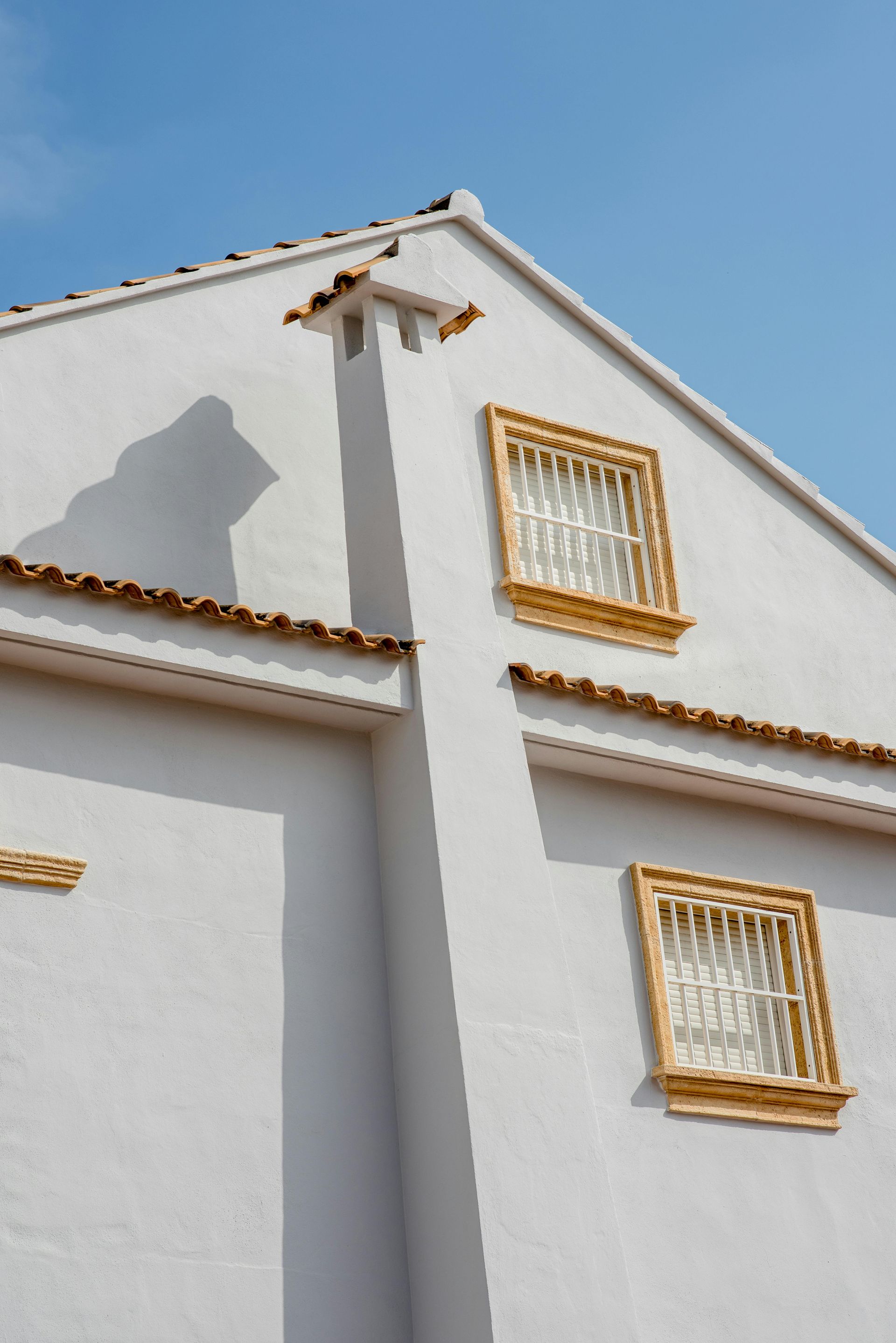 A white building with a blue sky in the background