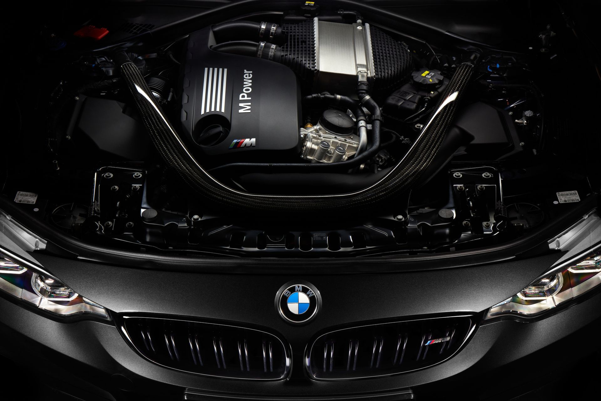 BMW car front with hood open, showing the engine bay and grille
