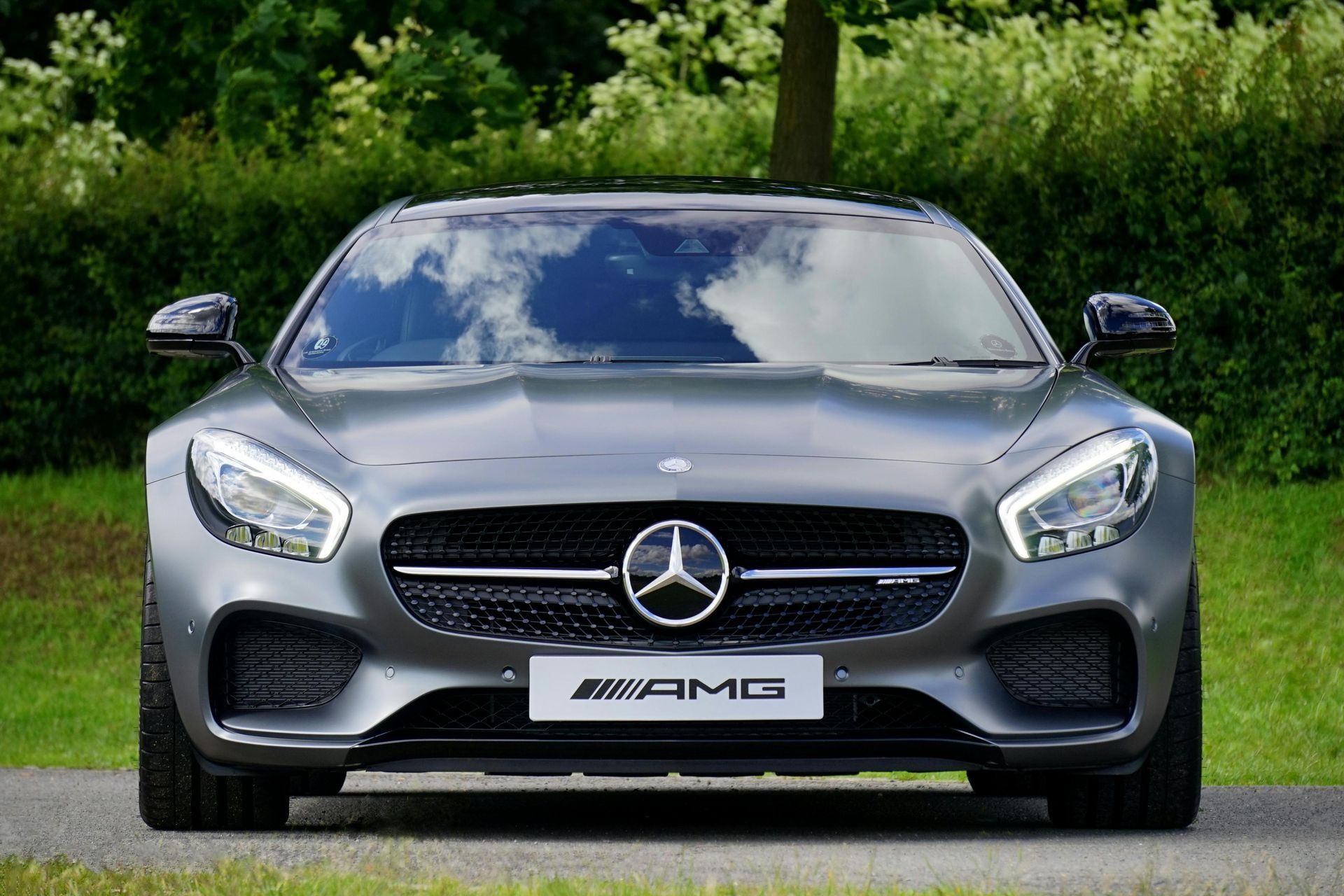 A grey Mercedes with a license plate that says amg