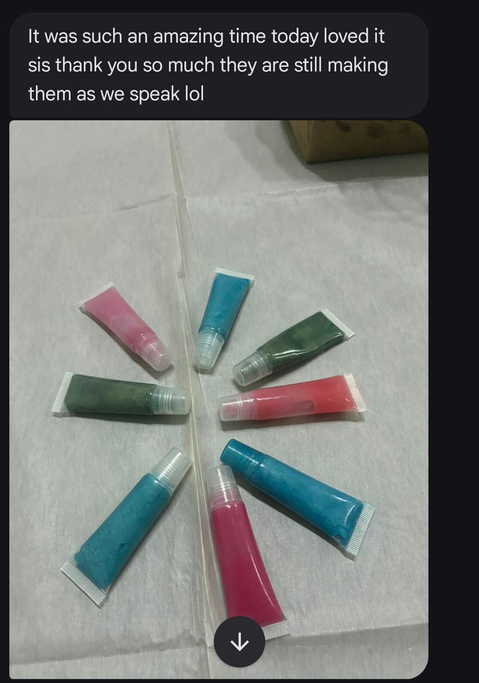 Colorful plastic tubes arranged in a circle on a white surface, shown in a phone chat screen screenshot