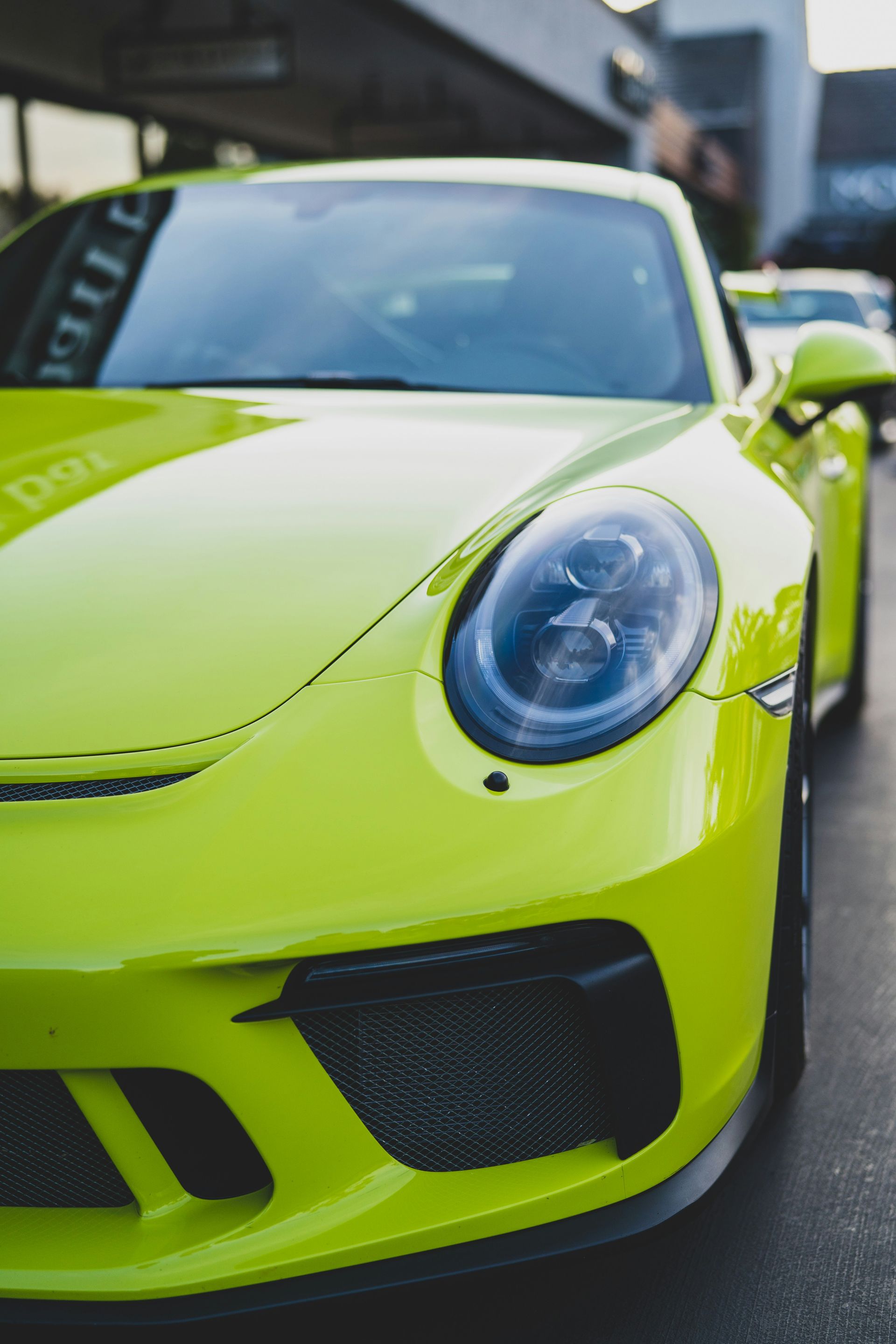 Bright lime green sports car photographed close-up on a city street
