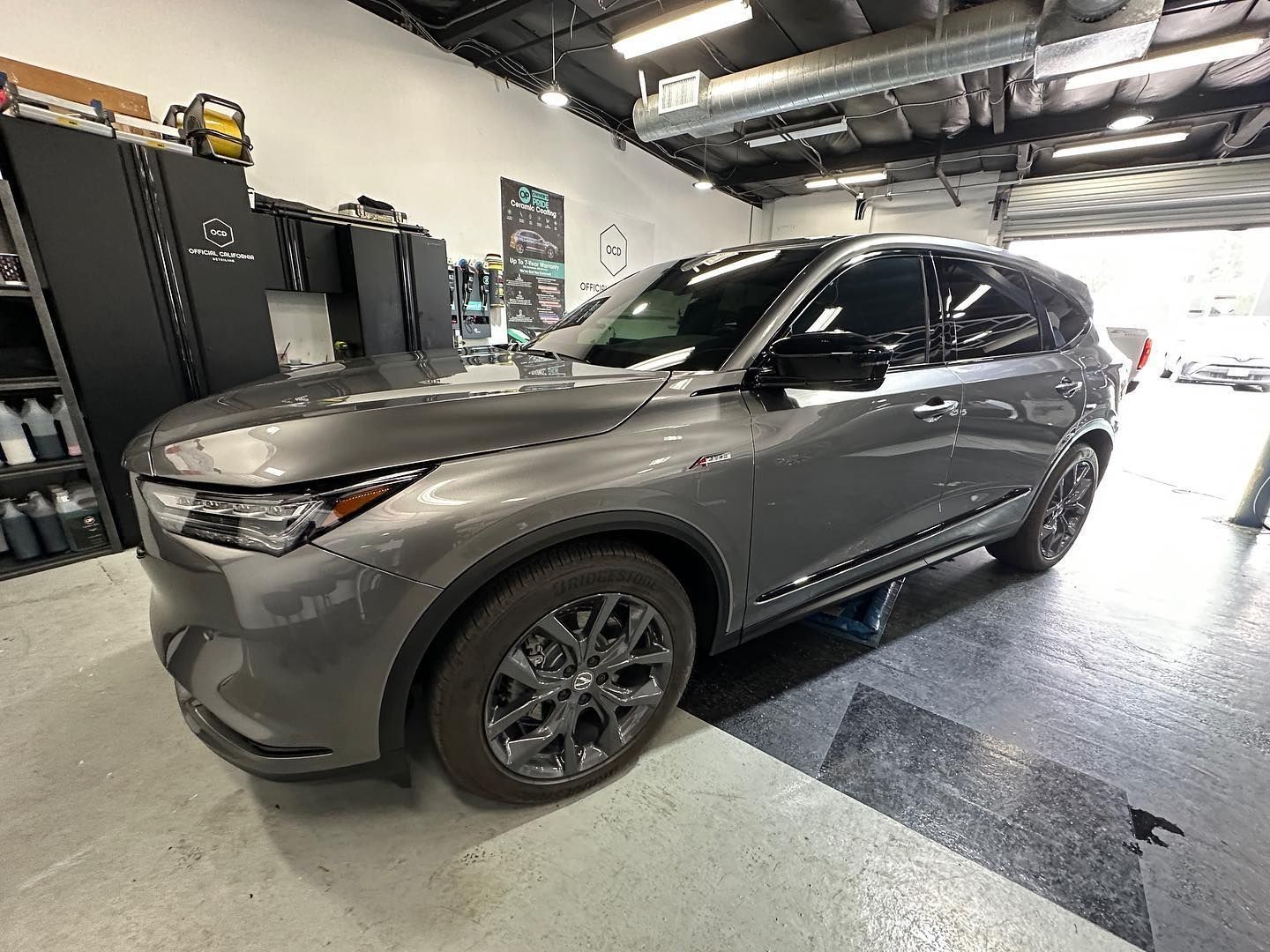 White BMW SUV parked indoors, front view with black grille and sharp LED headlights