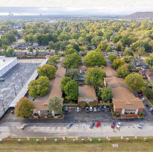 An aerial view of a residential area with lots of trees and buildings.