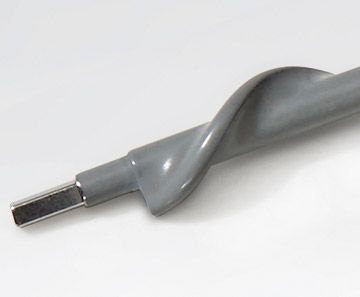 Close-up of a gray drill bit with a twisted shank and flat metal tip