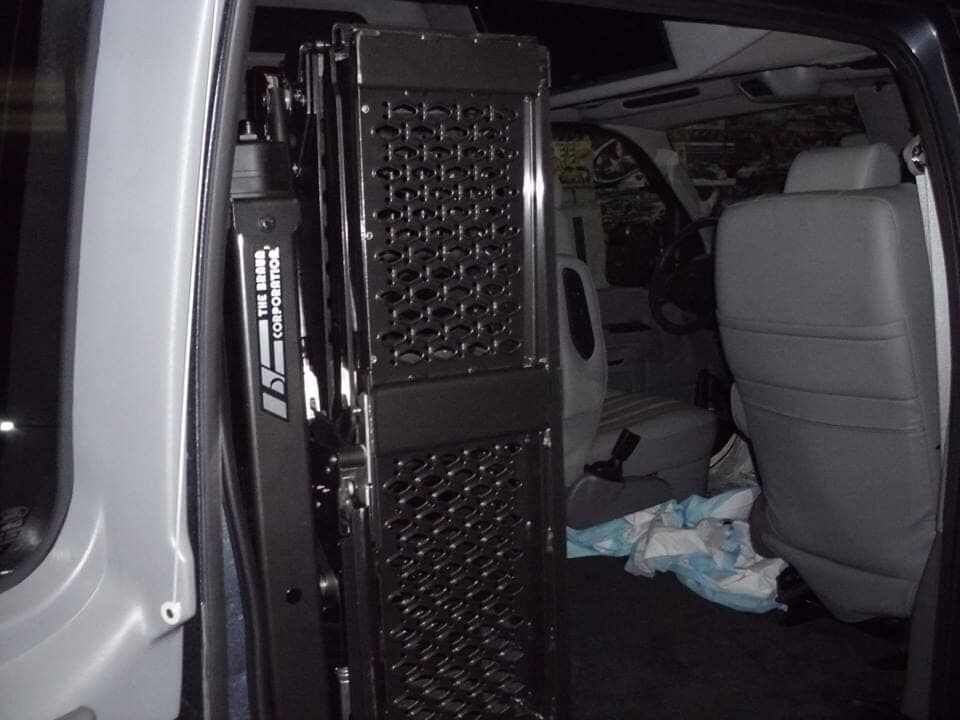 The inside of a van with a cage in the back