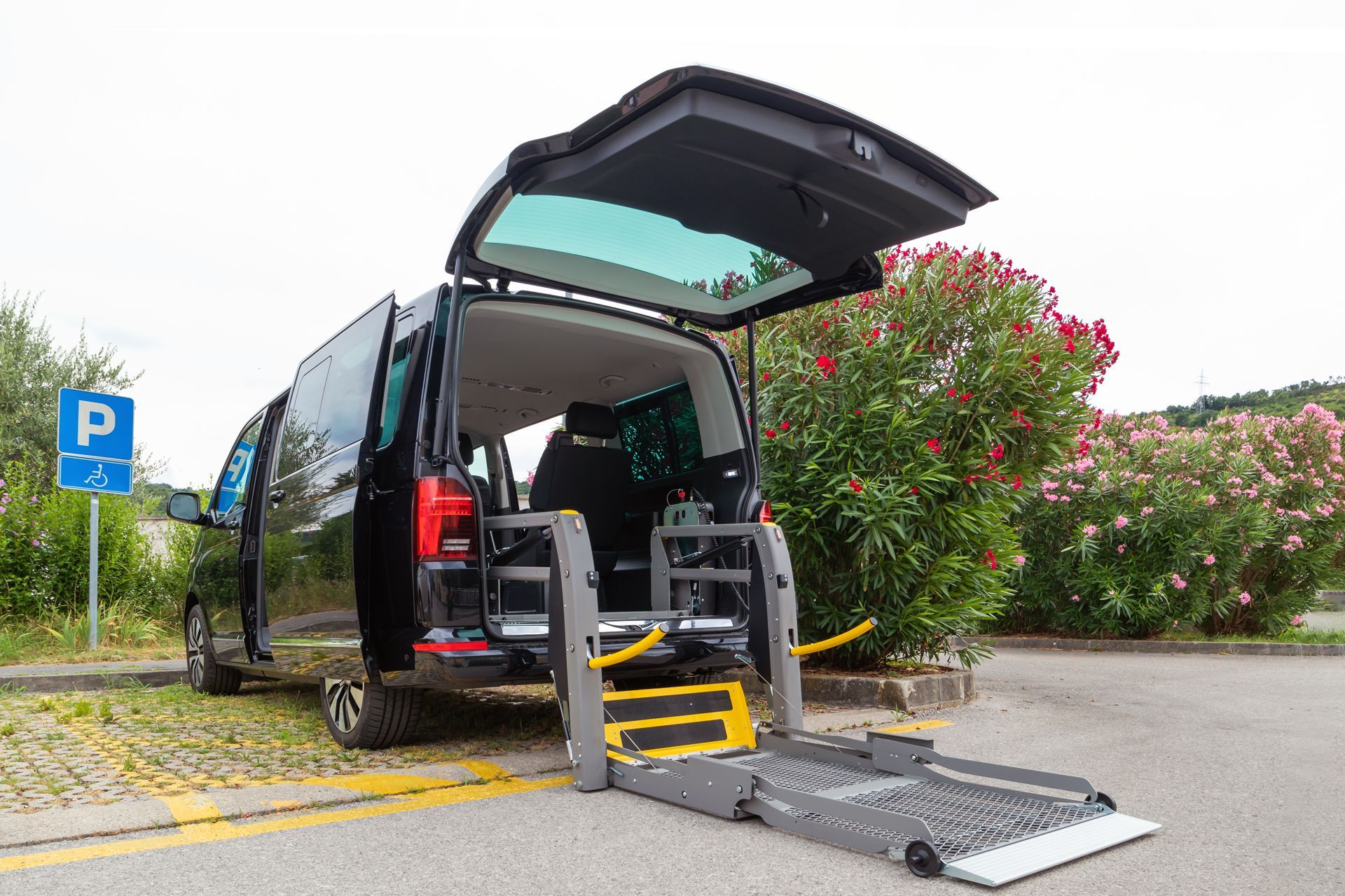 A Handicap Van With Its Trunk Open is Parked in a Parking Lot