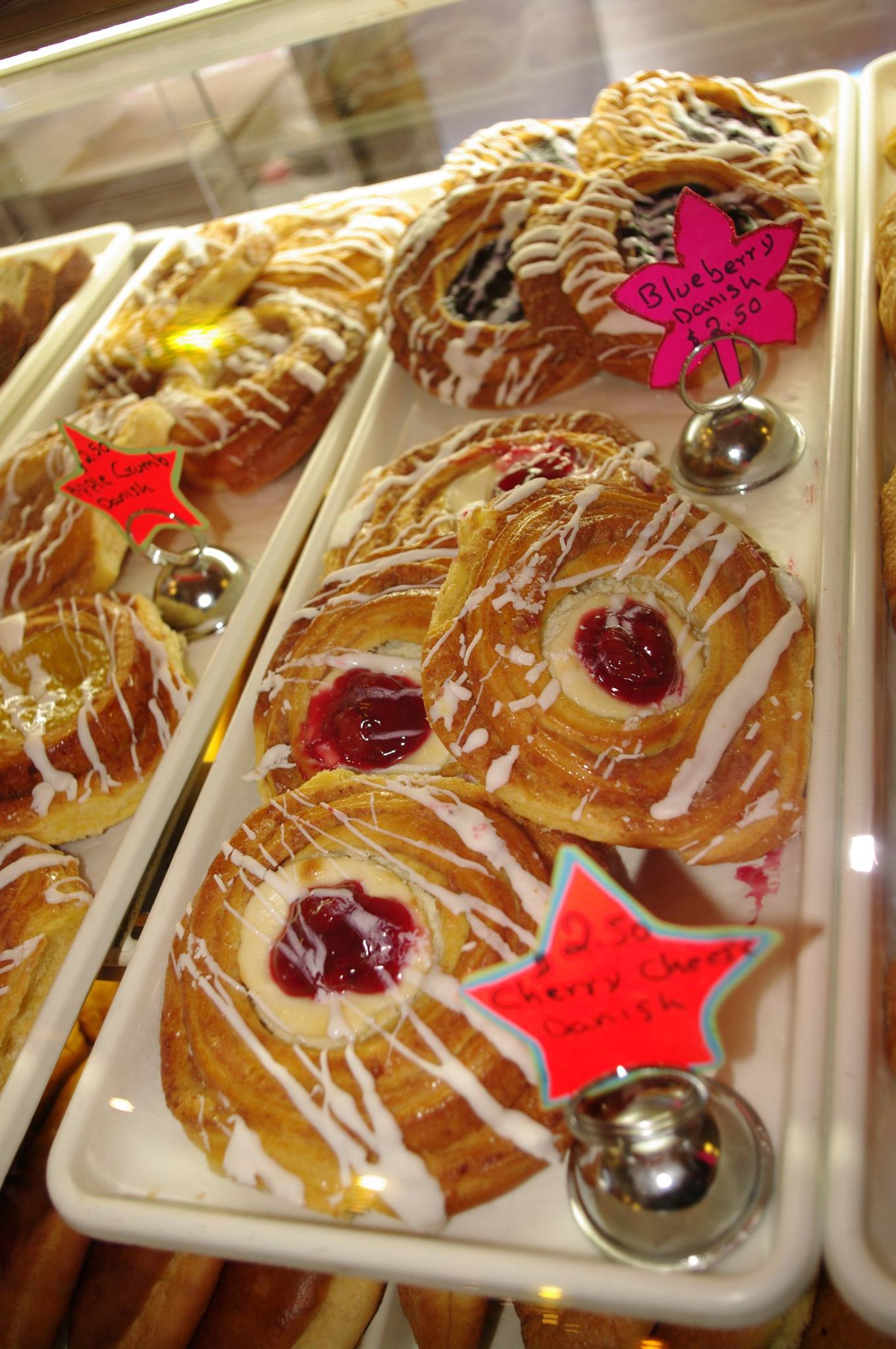 A variety of pastries are on display in a bakery