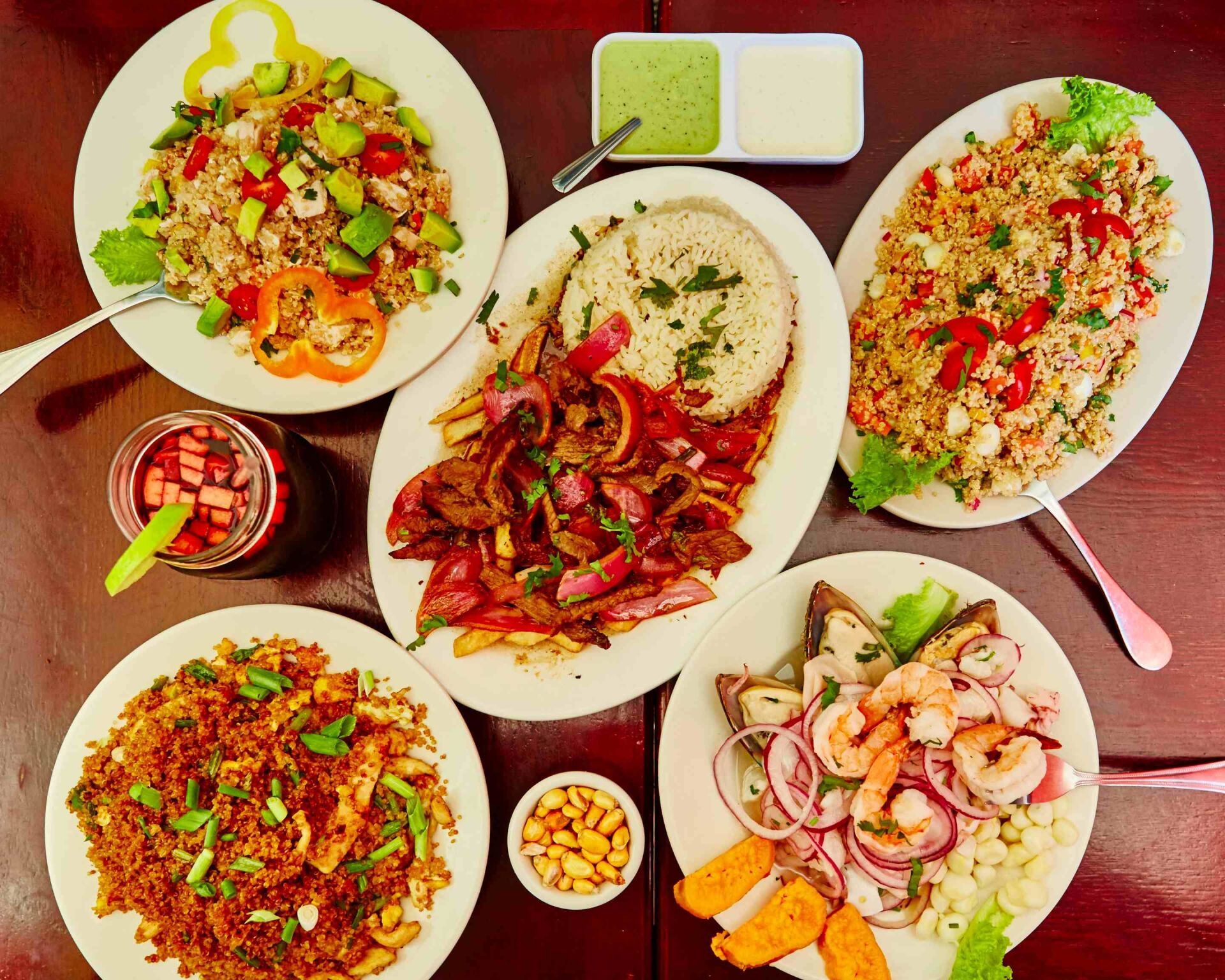 A table topped with plates of food and sauces