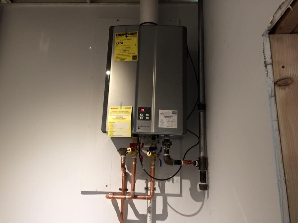 A water heater is hanging on a wall in a room.