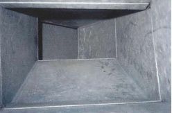 A very narrow room with a shelf in the middle of it.