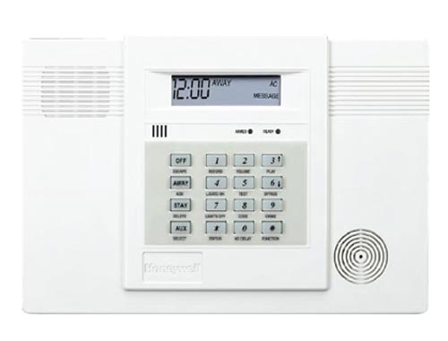 A white security system with a clock on it