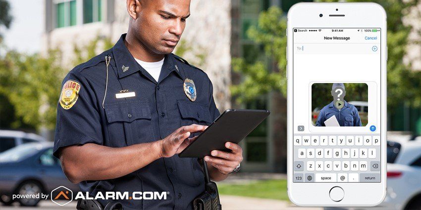 A police officer is looking at a tablet next to a cell phone.