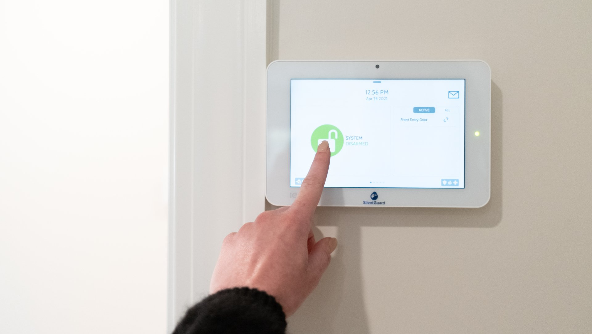 A person is pressing a button on a security system.