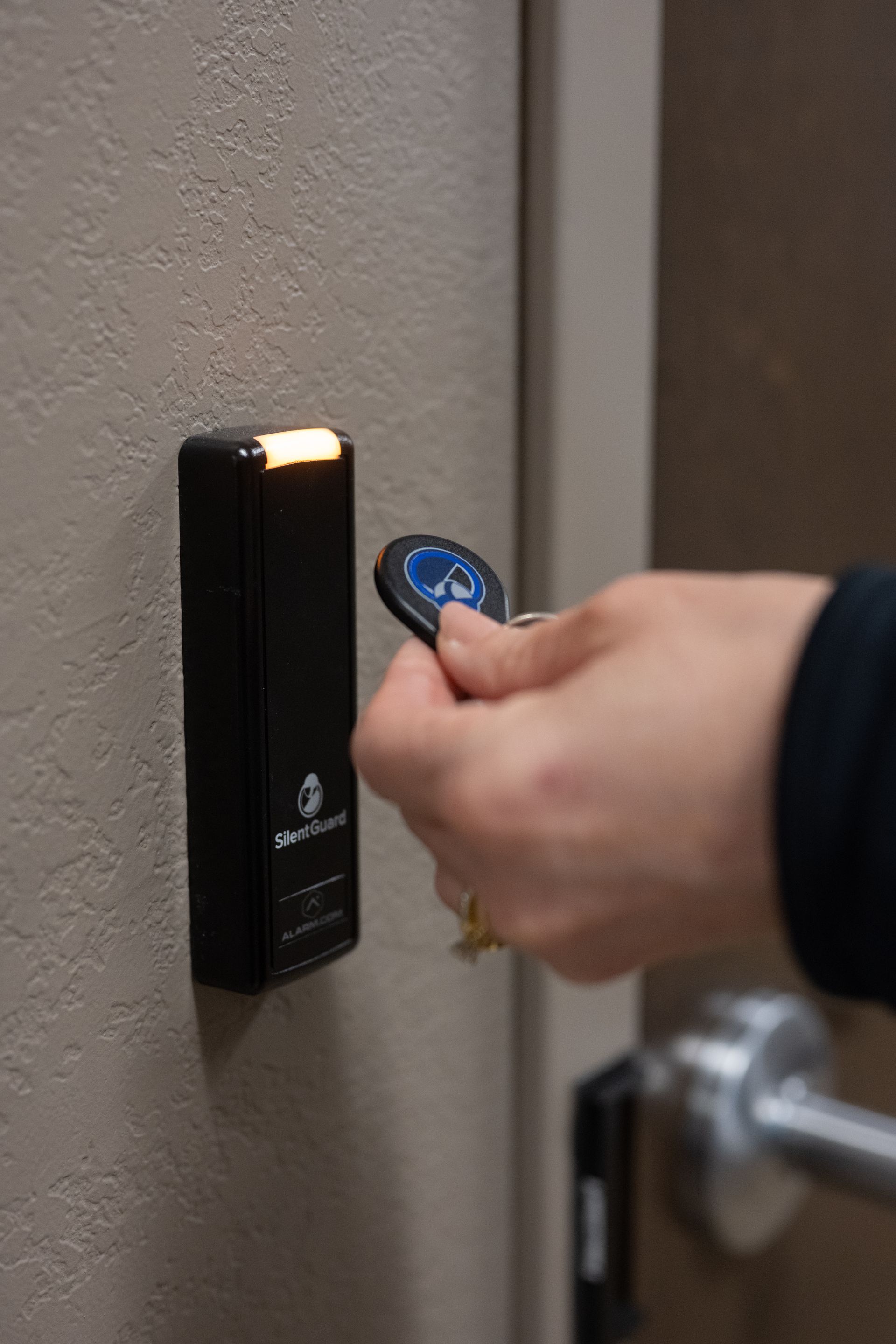 A person is using a key to open a door.