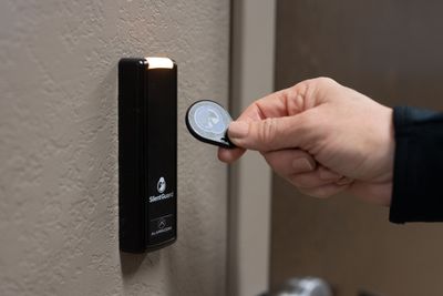 A person is using a key to open a door.