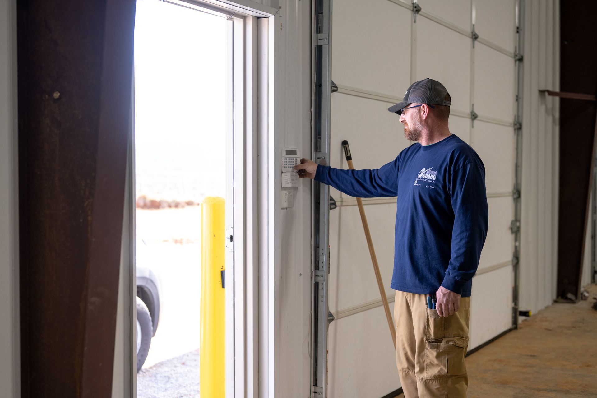 A man is standing in front of a garage door.