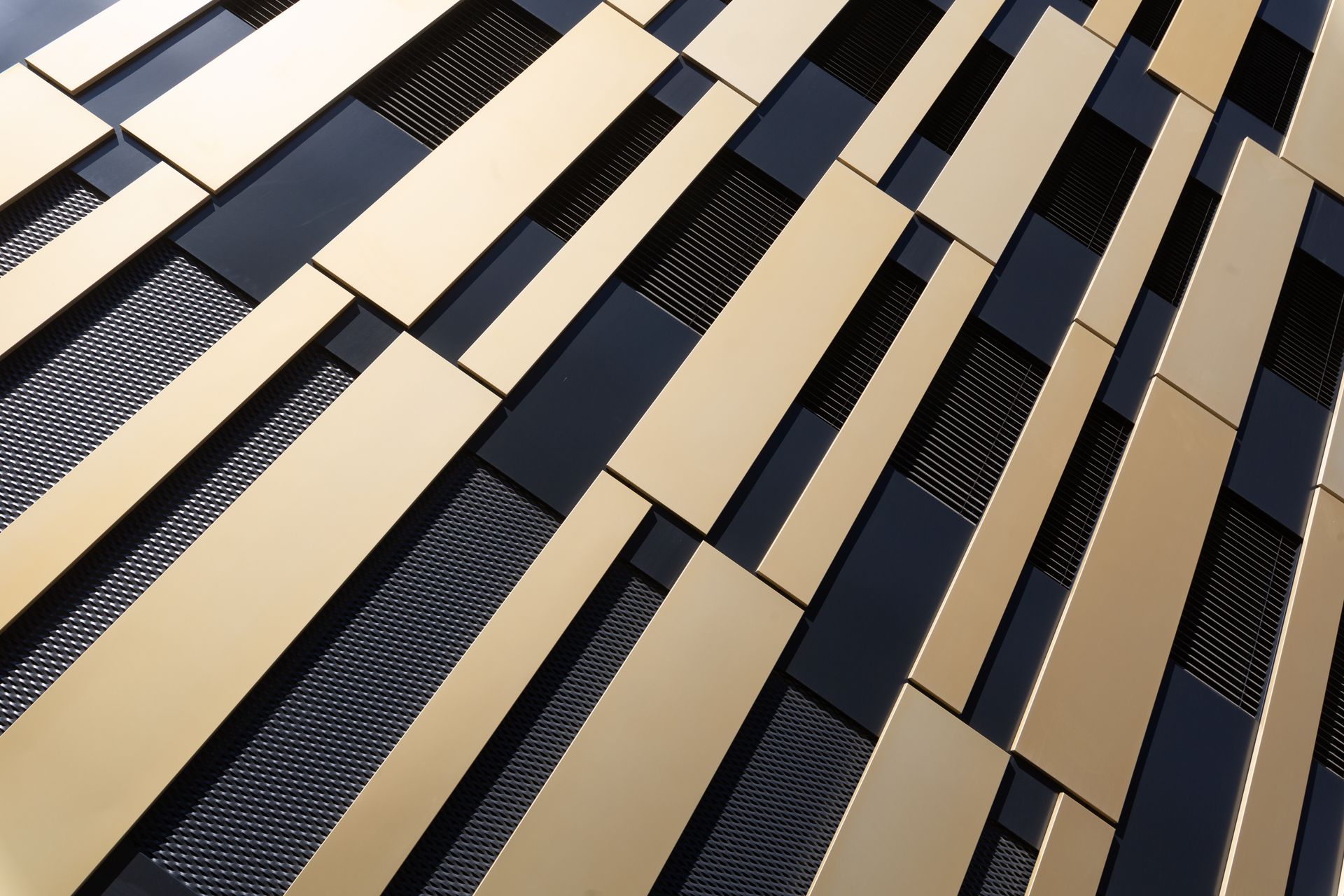 Gold and black geometric architectural facade with rectangular panels.