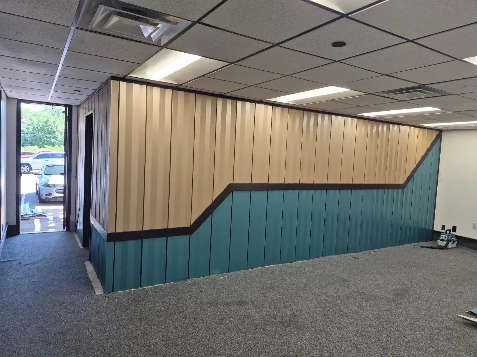 Two-tone interior wall with vertically oriented panels and dark angled trim.