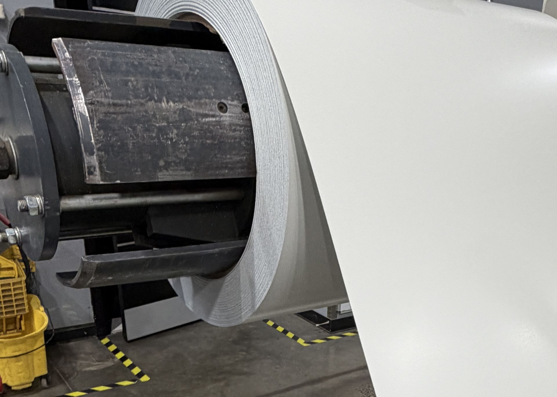 Coil material mounted on processing equipment in the ASF shop.