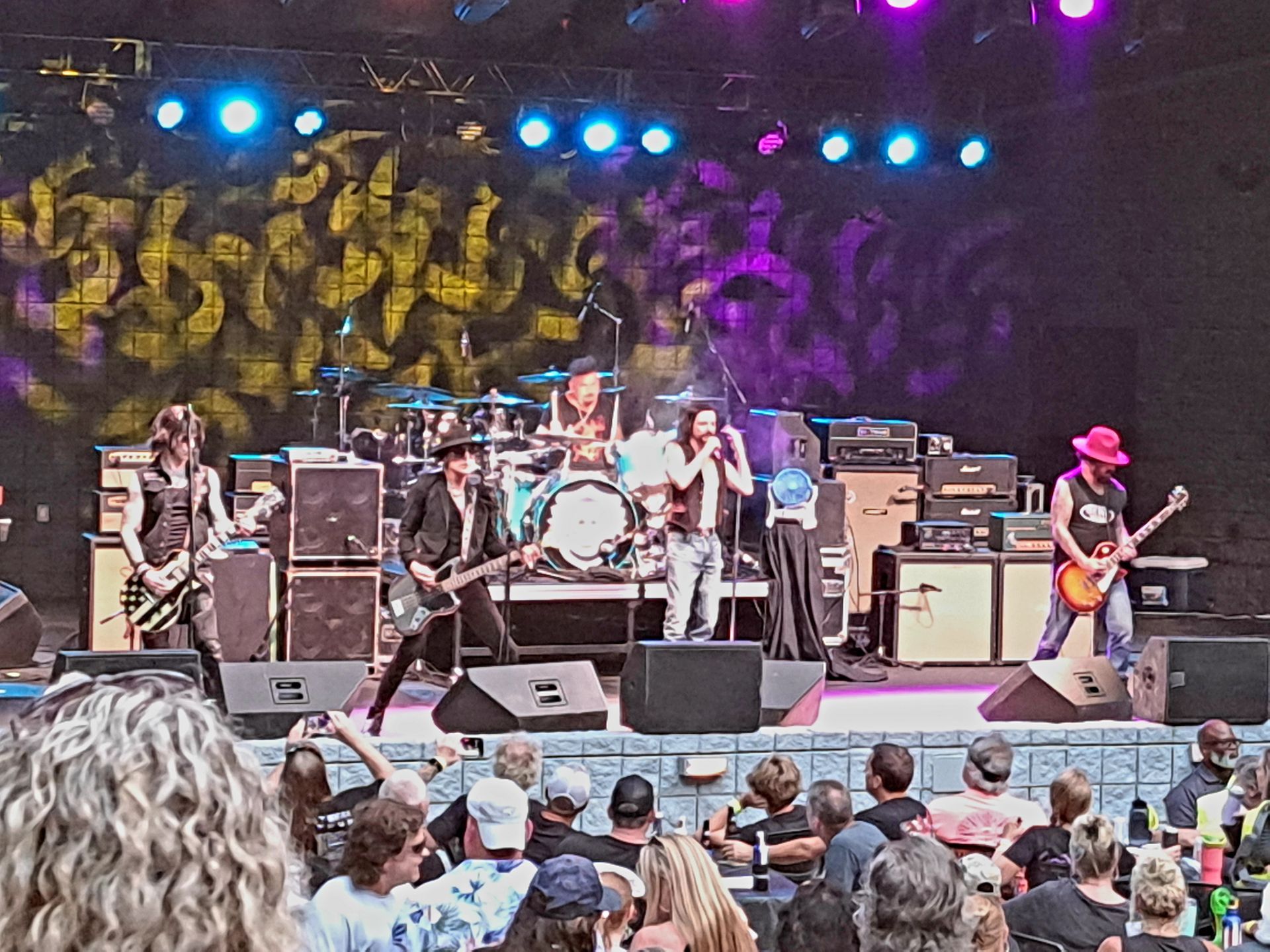 A group of people are watching a band on stage