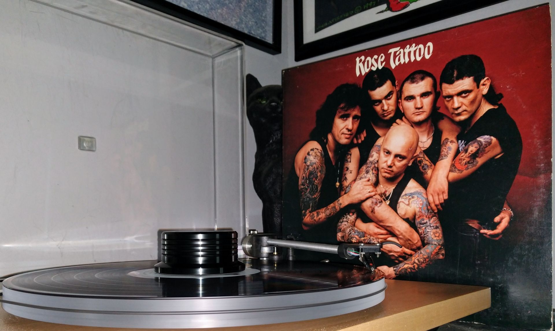 A record player is playing a record of rise tattoo
