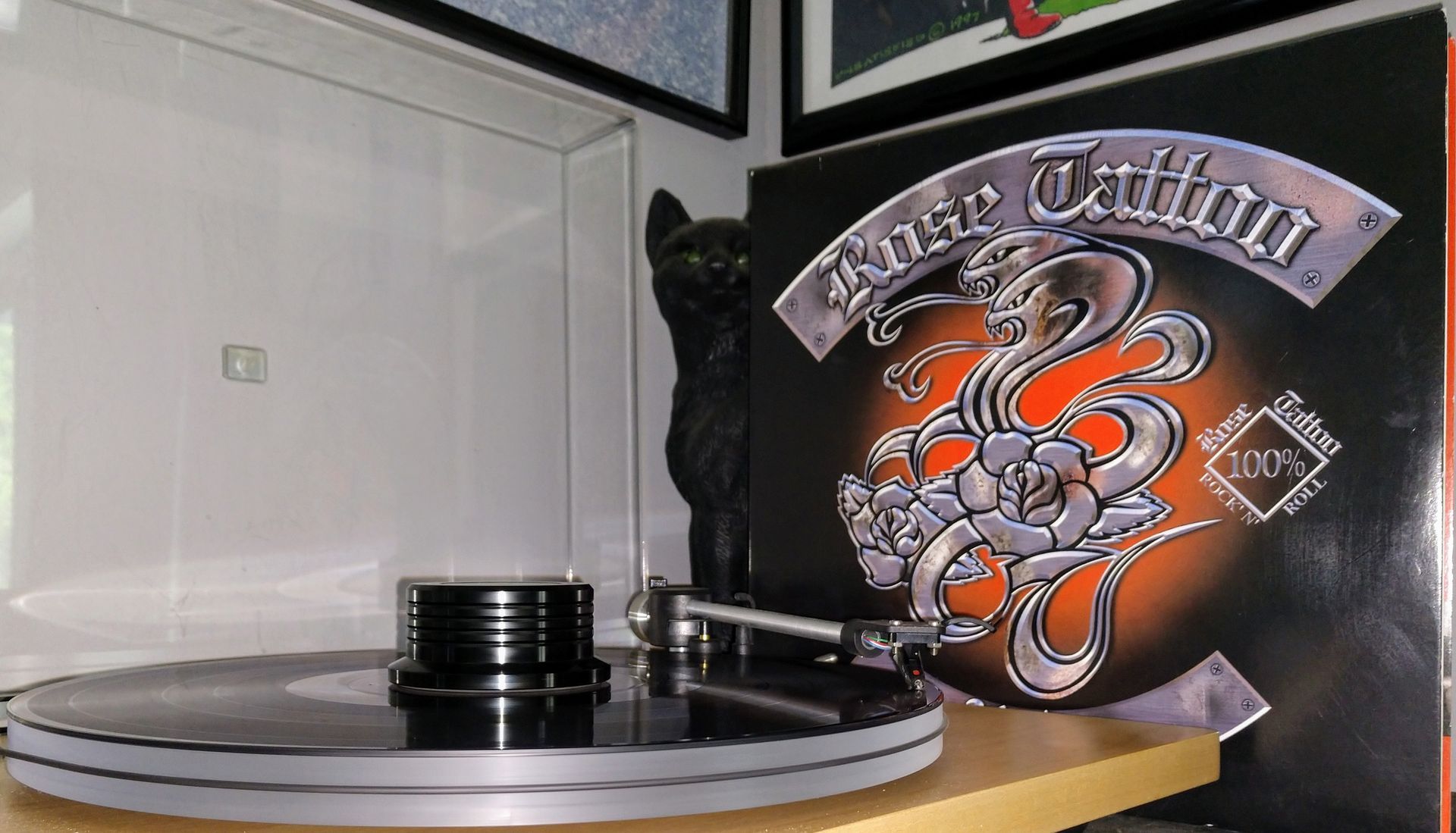 A record player is playing a record titled bad tattoo