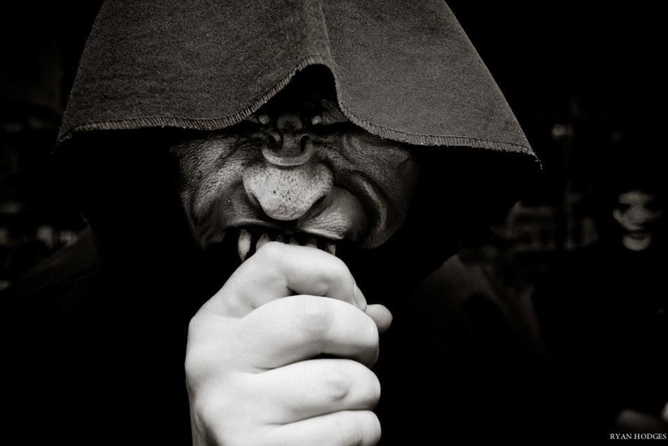 A black and white photo of a person with a mask on their face.