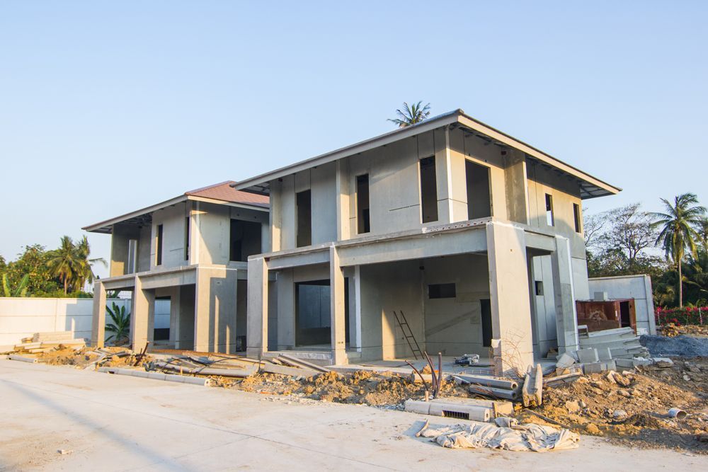 A large house is being built in a residential area.