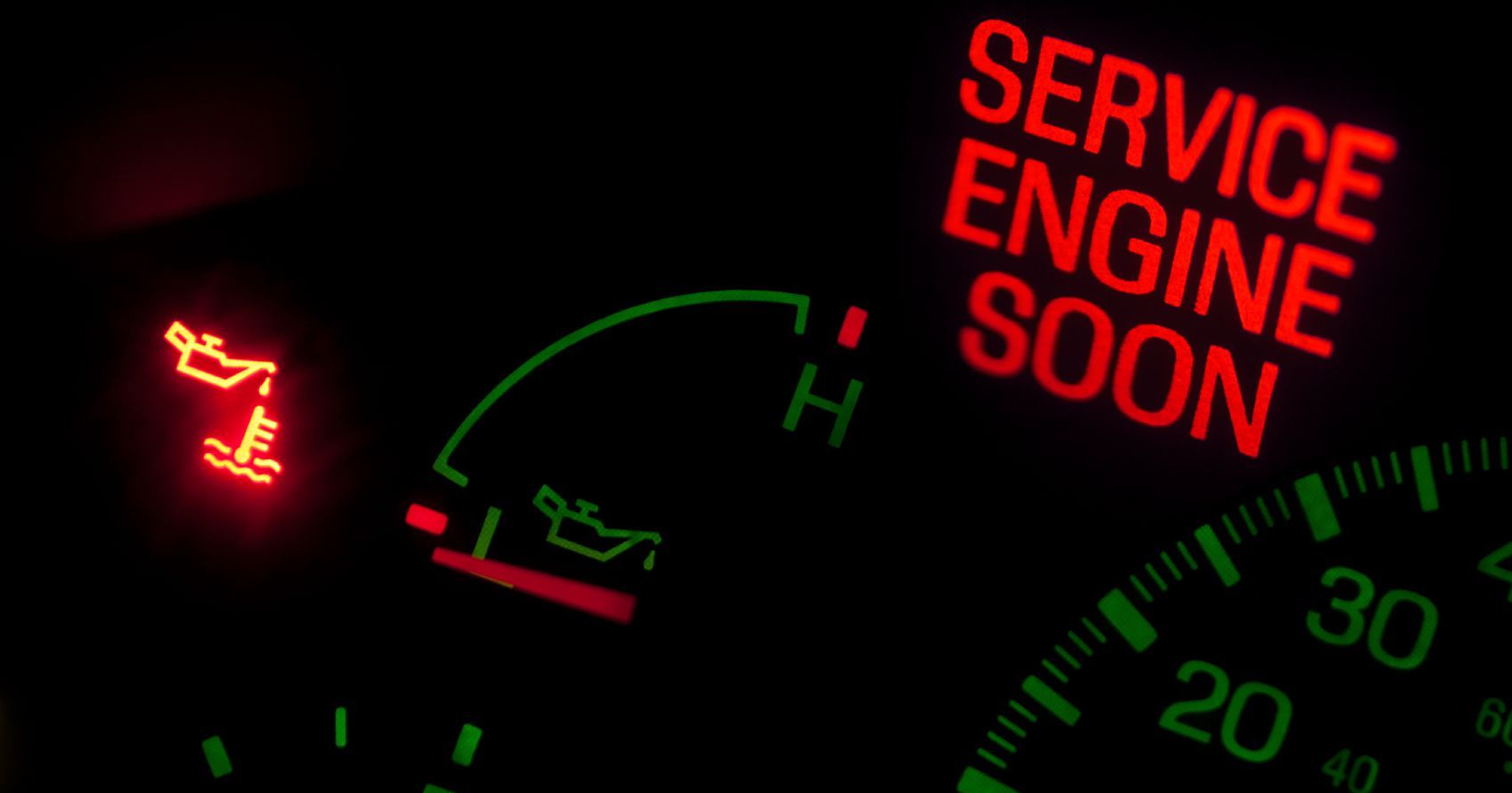 A close up of a service engine soon sign on a car dashboard