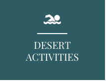 A blue sign with a swimming icon and the words `` desert activities ''.